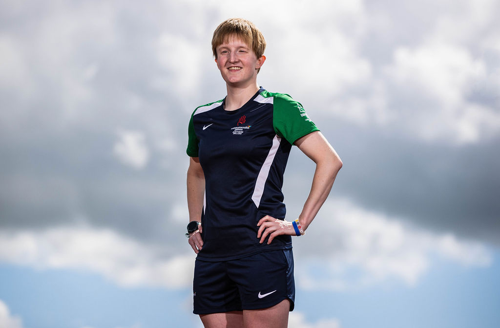 Chloe MacCombe standing with her hands on her hips. Chloe is wearing her Commonwealth Games Training Kit.