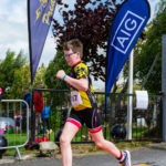 Youth triathlete crossing finish line