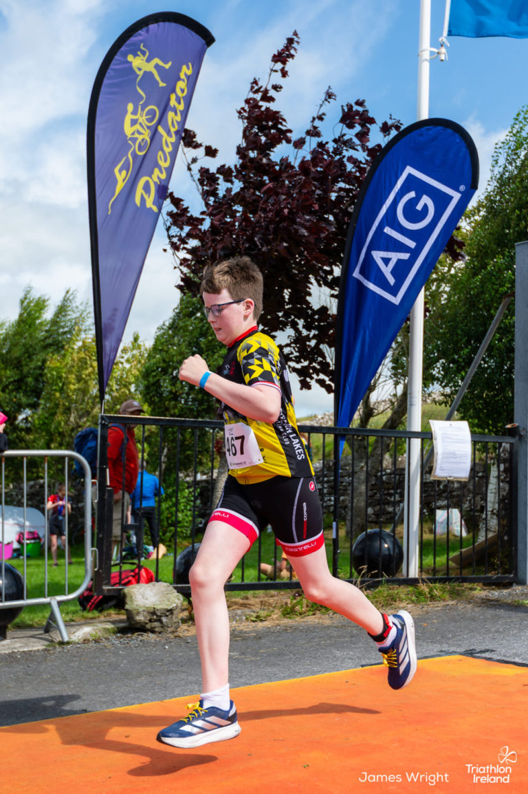 Youth triathlete crossing finish line