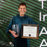Anne Paul holding award in the Triathlon Ireland Hall of Fame