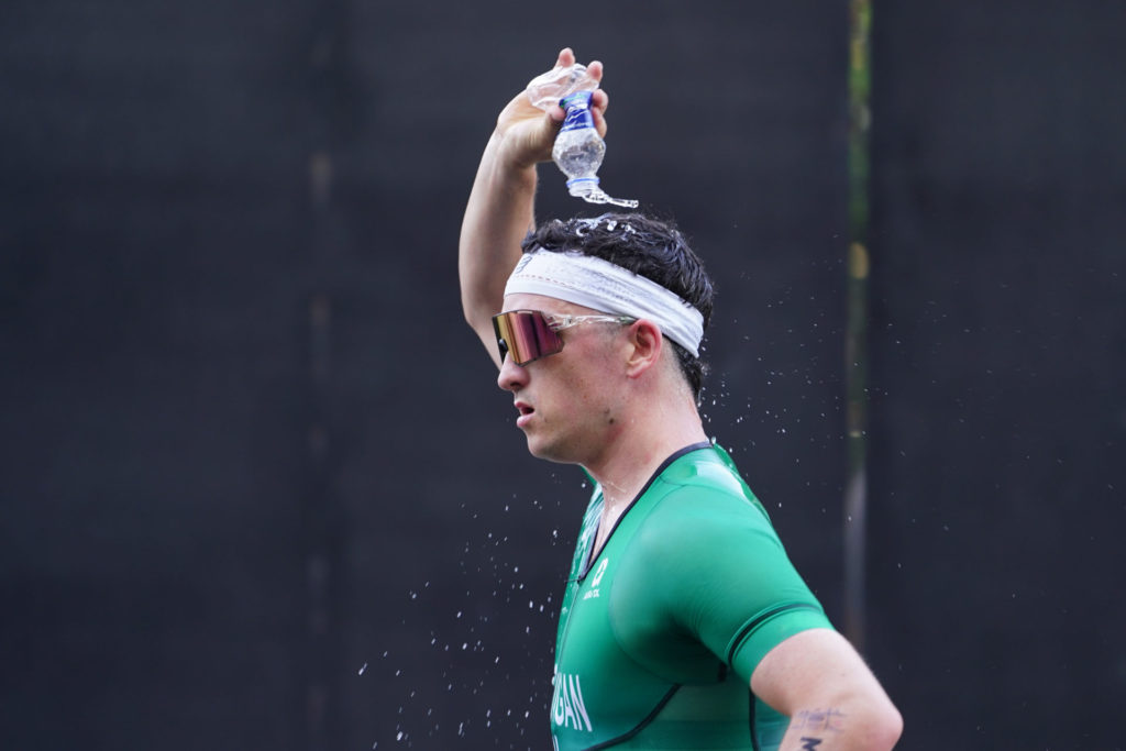 Tri Team Ireland running racing on road pouring water on head