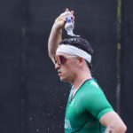 Tri Team Ireland running racing on road pouring water on head