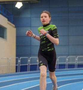 Youth Triathlon Commission Members 2026 - Girl running indoor track