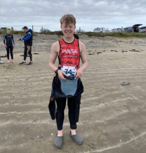 Youth Triathlon Commission Members 2026 - Boy standing on beach