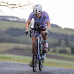 smiling Cyclist going up hill at duathlon