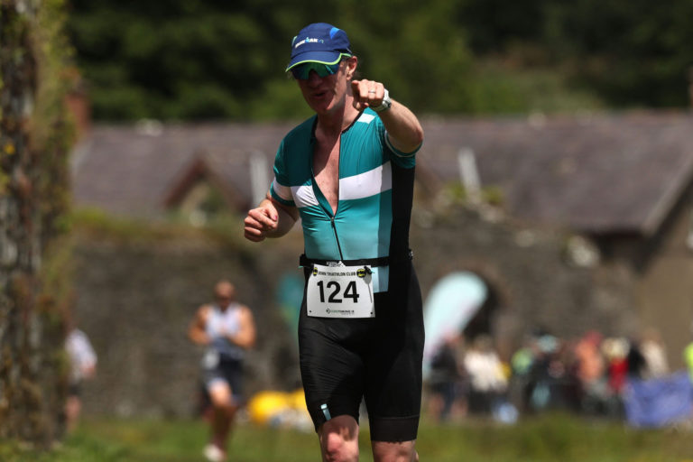 Pointing man Beyond the Wall Triathlon 2026